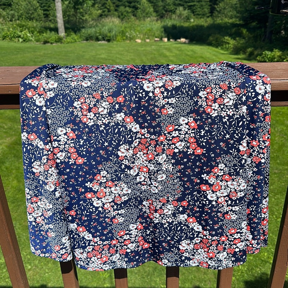Navy blue mid length skirt with coral and white flowers. Xl